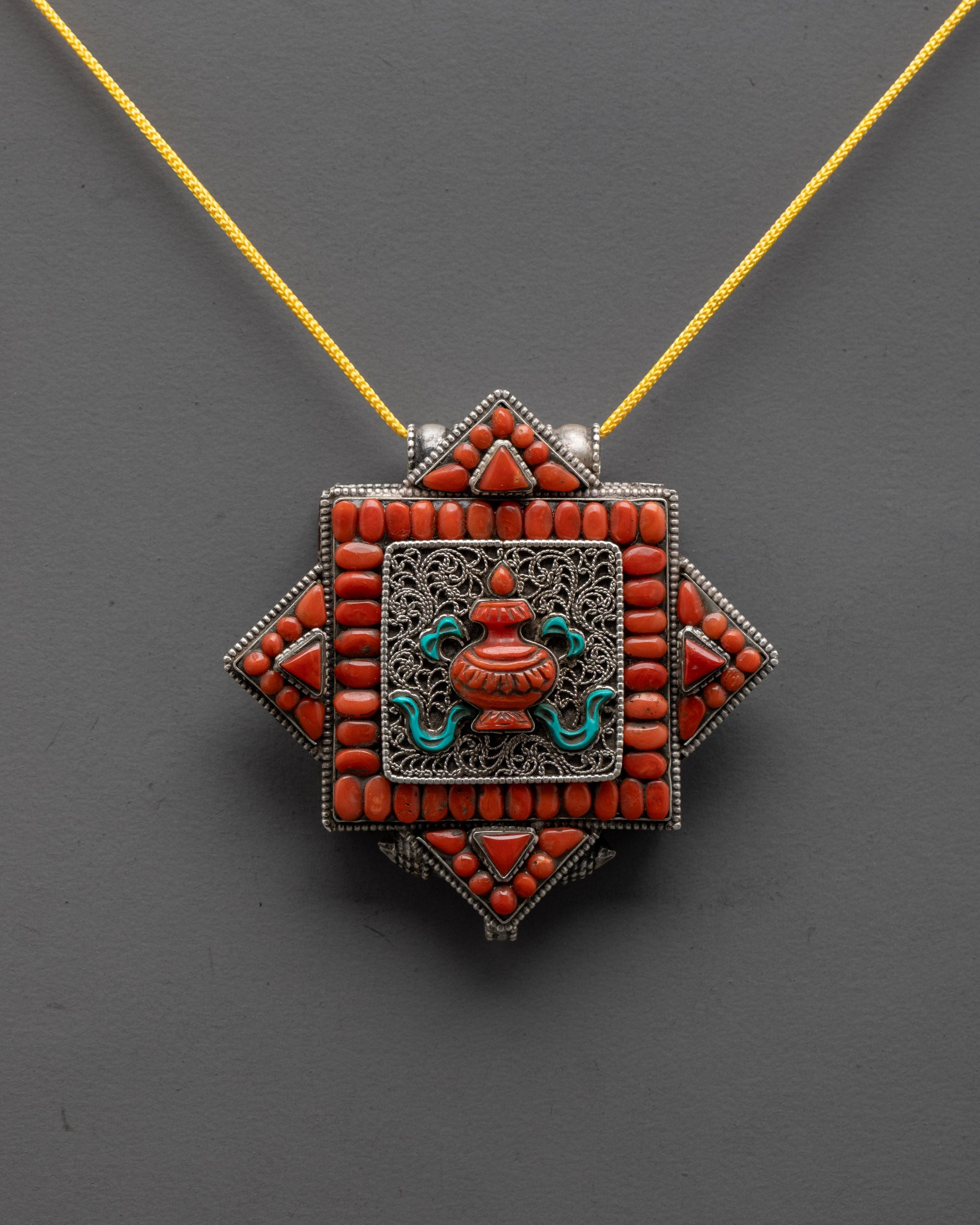 Front view of Treasure Vase Locket Necklace with silver, coral, and turquoise stones