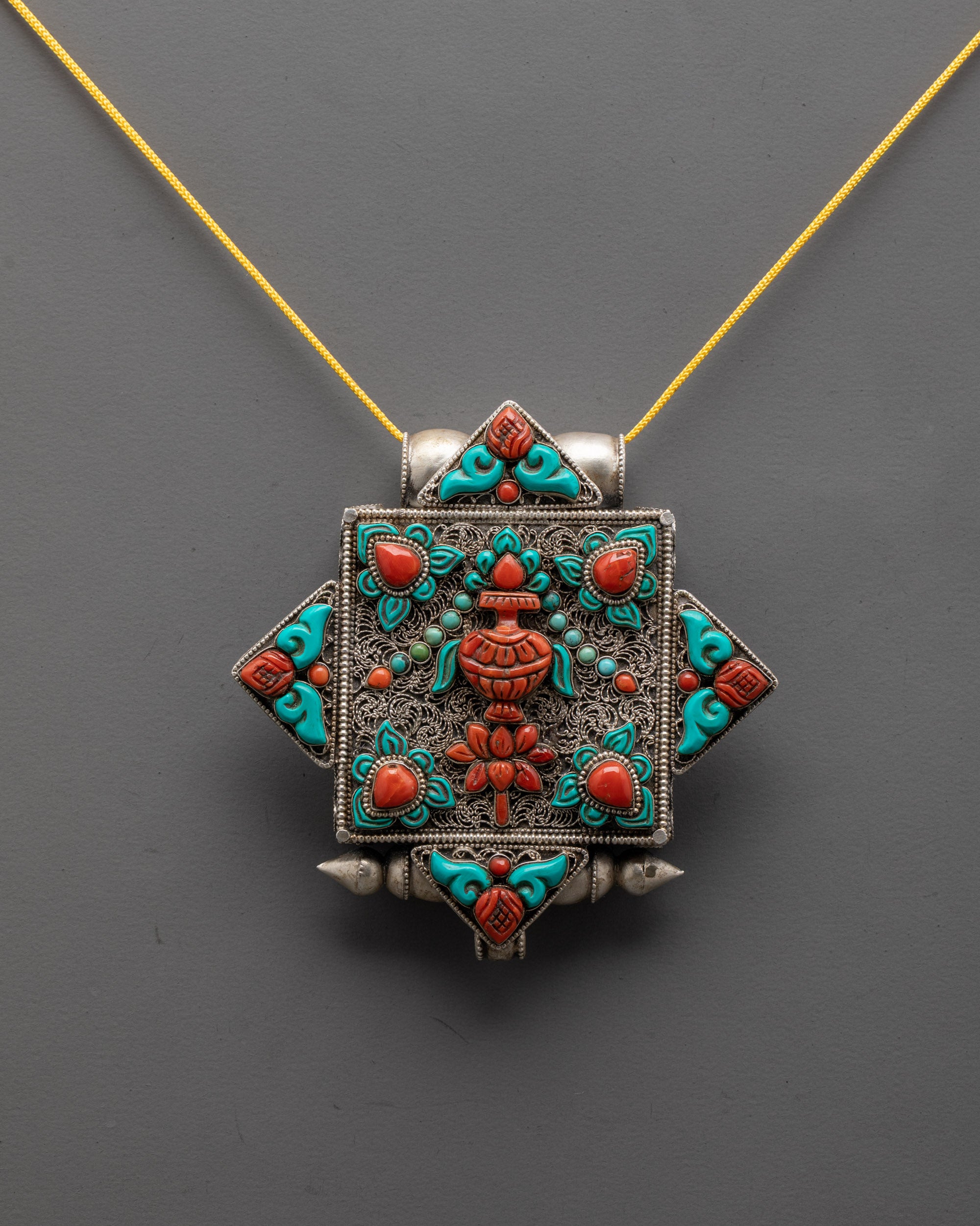 Front view of Treasure Vase Locket with silver body and coral turquoise stones
