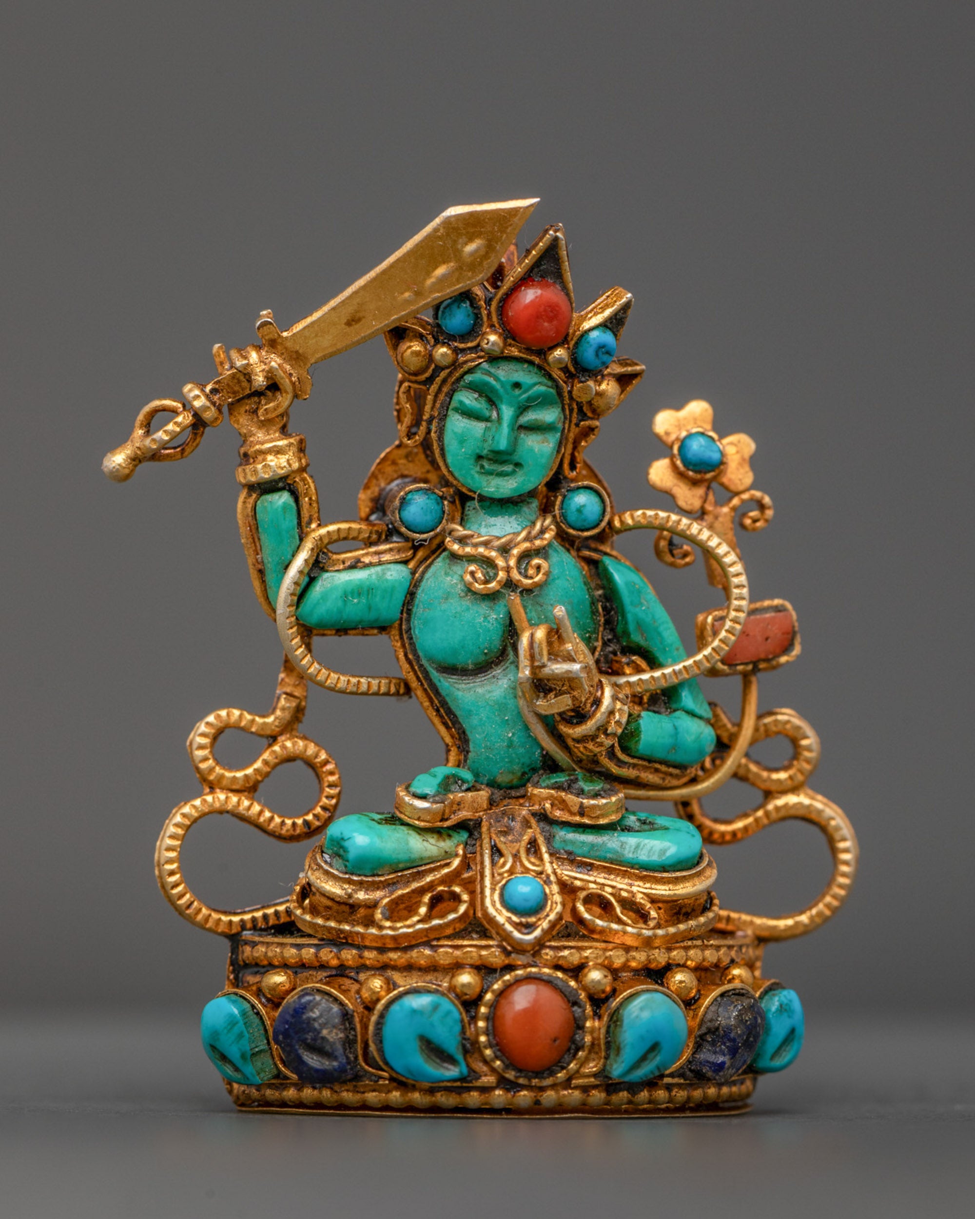 Front view of Turquoise Manjushri Locket with gold-gilded sword and lotus seat

