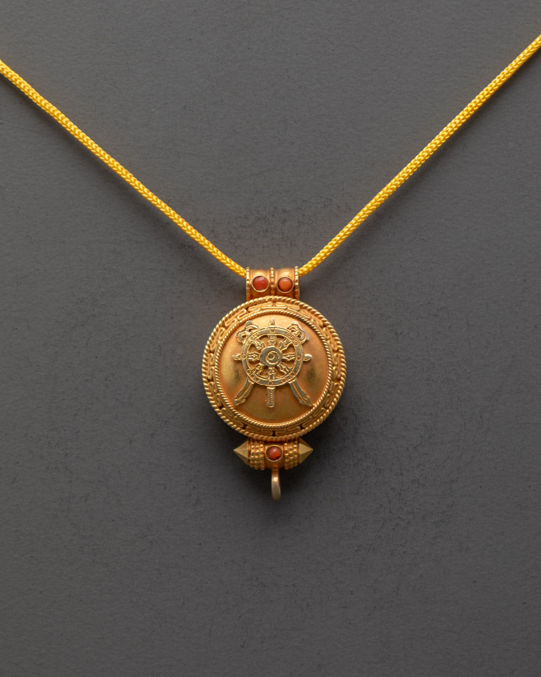 Front view of Wheel of Wisdom Locket with Khorlo design and semi-precious stones