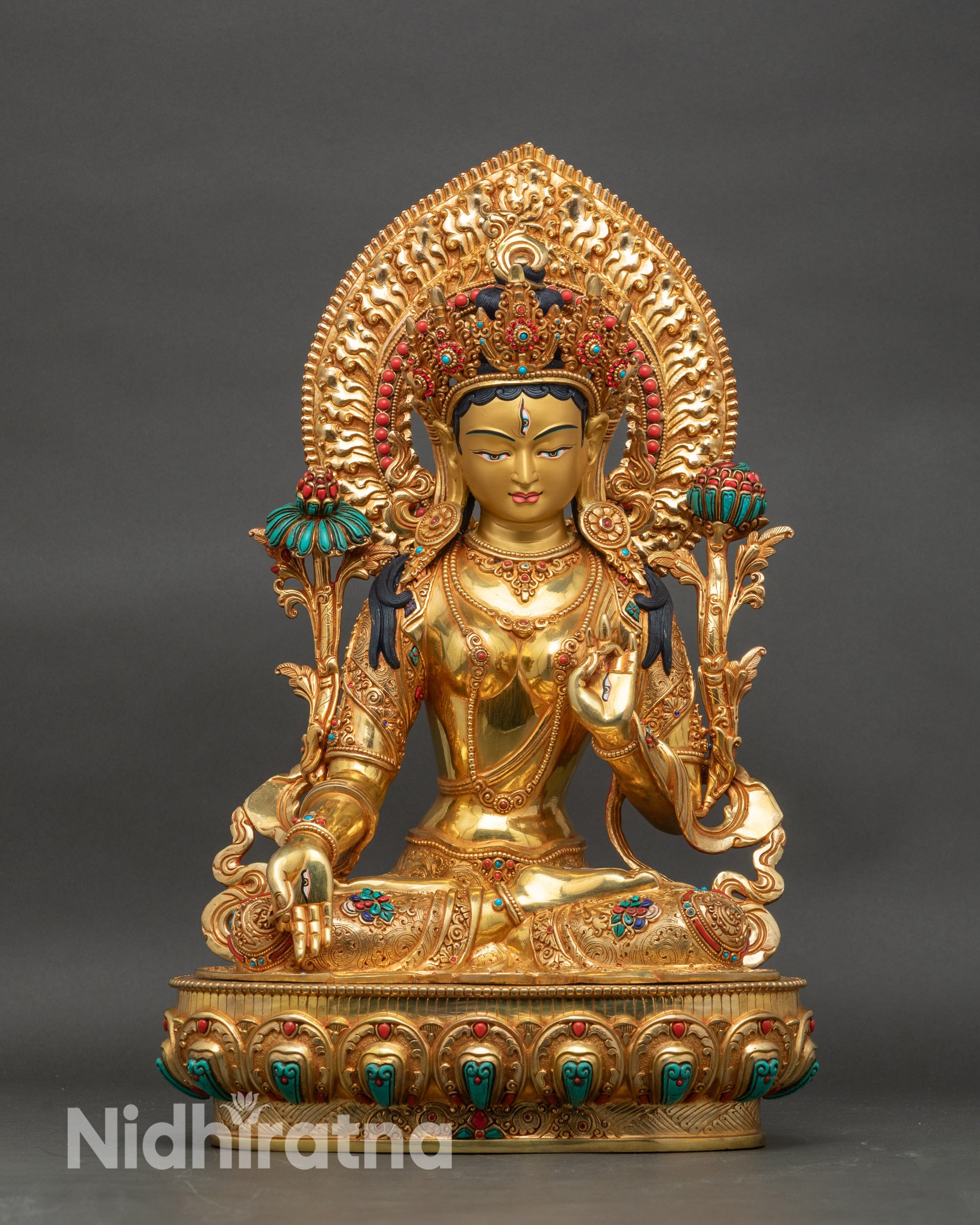 Front view of White Tara statue seated on lotus with gold fire-gilded copper finish
