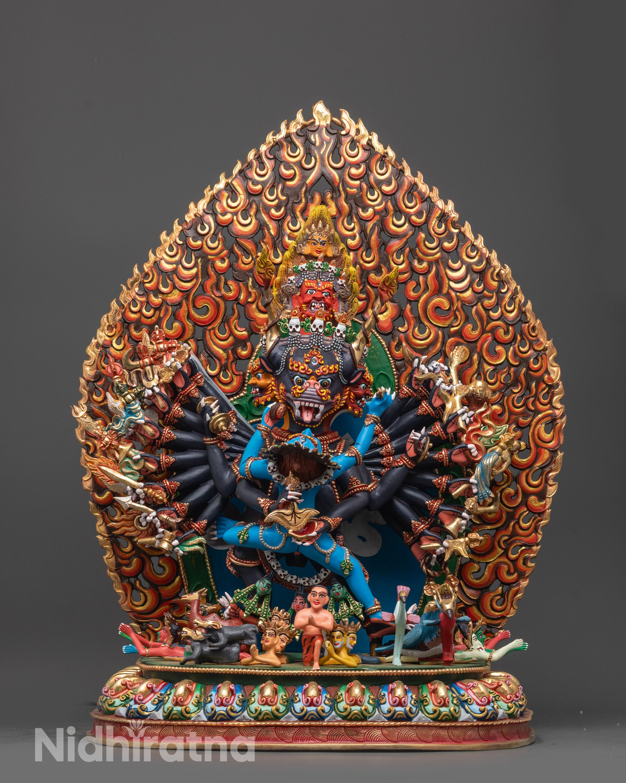 Front view of Yamantaka Consort Statue showing nine faces and sixteen arms on lotus seat