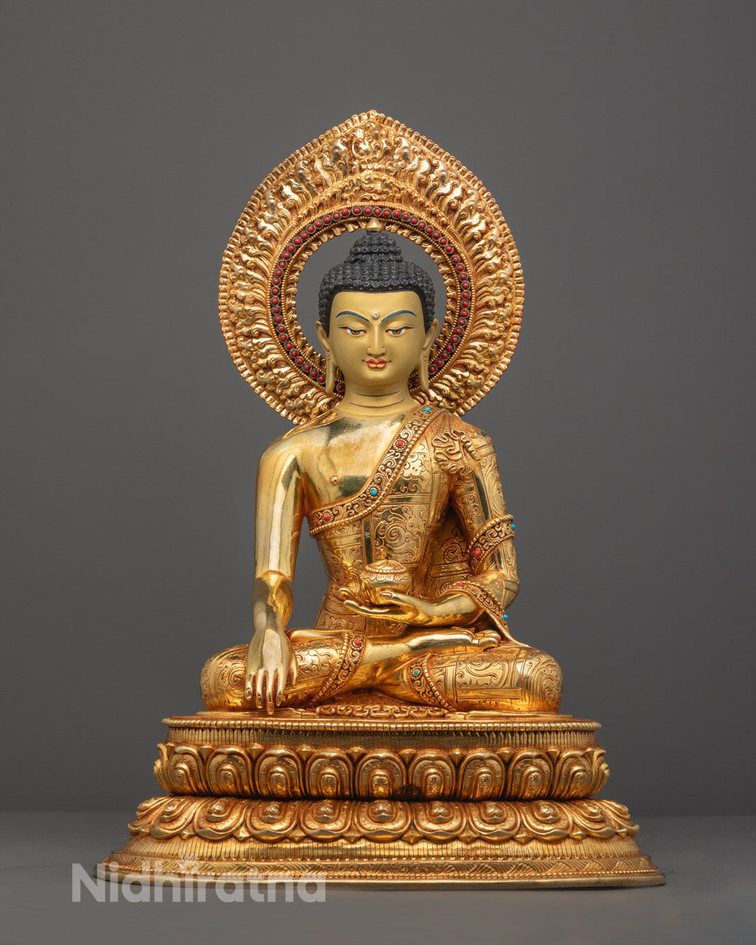 hand-carved Siddhartha Gautama Buddha statue in meditation pose, featuring an oxidized copper body and 24K gold-plated face on a lotus throne.
