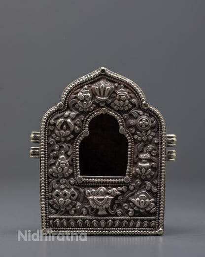 Front view of a hand-carved silver-plated Tibetan Ghau Box with intricate floral 