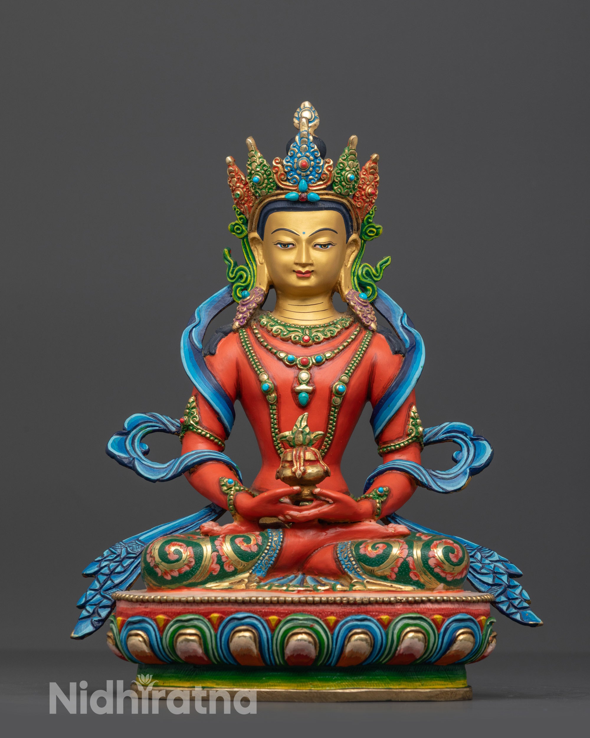 Front view of a handcrafted red Amitayus Buddha statue from Nepal on a lotus base.
