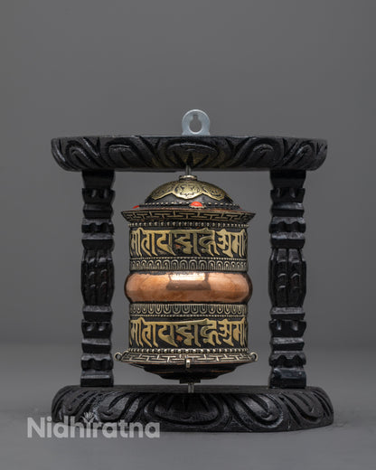 Front view of artisan-made copper Tibetan prayer wheel with brass and coral details