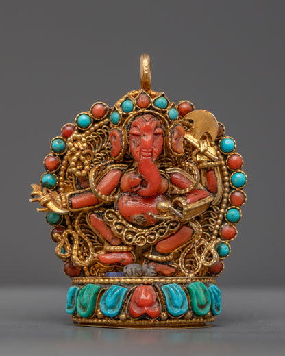 Front view of coral Ganesh locket with gold filigree and semi-precious stones on lotus seat