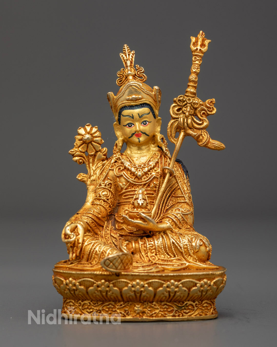 Front view of gold-plated Guru Rinpoche statue on lotus throne with vibrant painted details