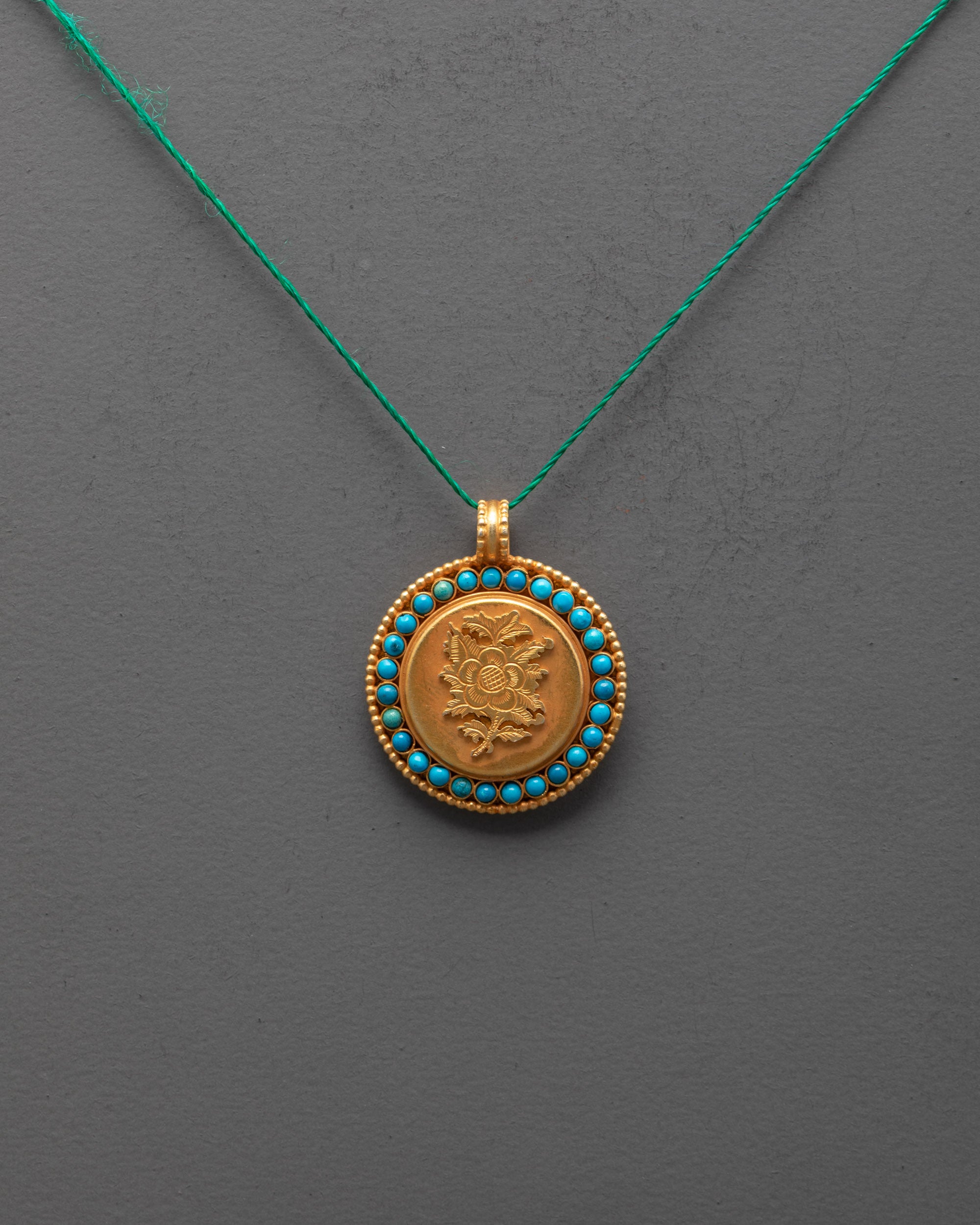 Front view of gold-plated Lotus Locket with semi-precious stones, handmade in Nepal