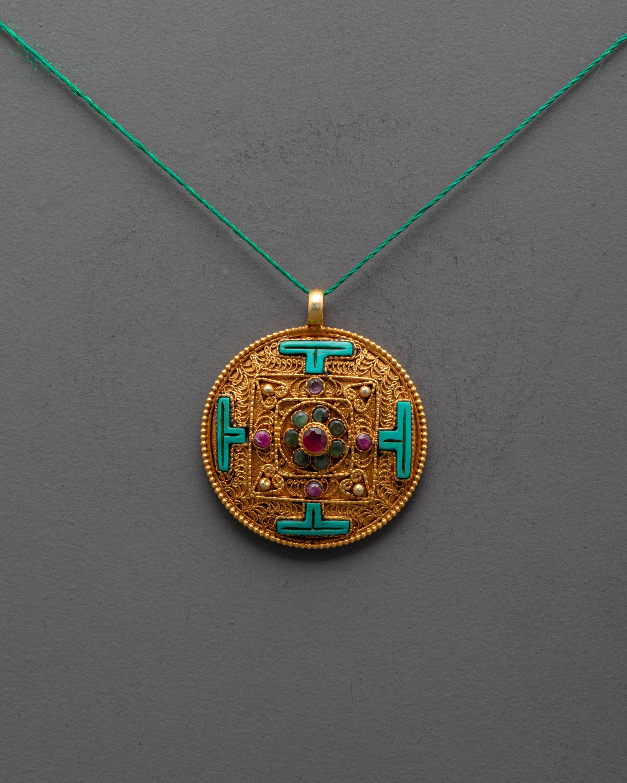 Front view of gold-plated Mandala Locket with filigree and semi-precious gems