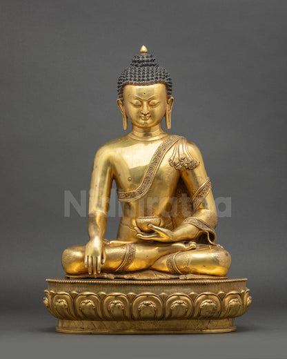 Front view of gold fire-gilded Dhyana Shakyamuni Buddha statue from Nepal seated in meditation
