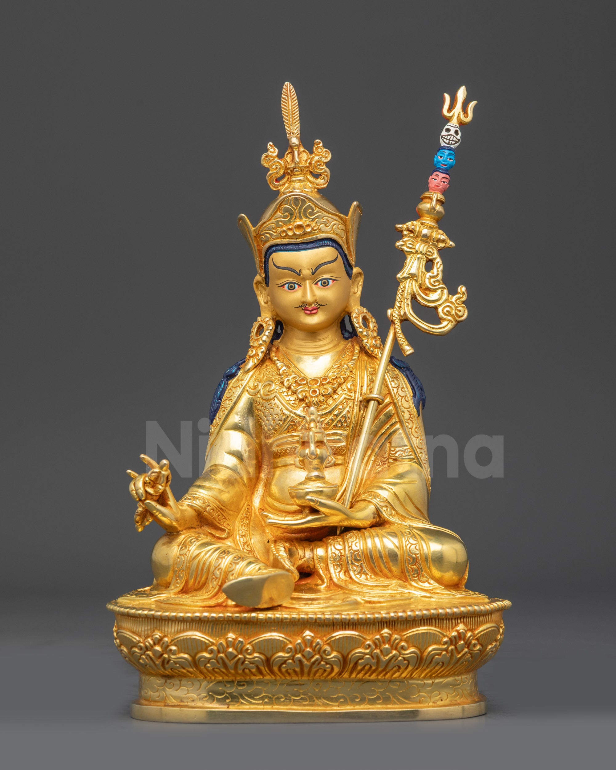 Front view of gold fire-gilded Guru Padmasambhava statue on lotus seat