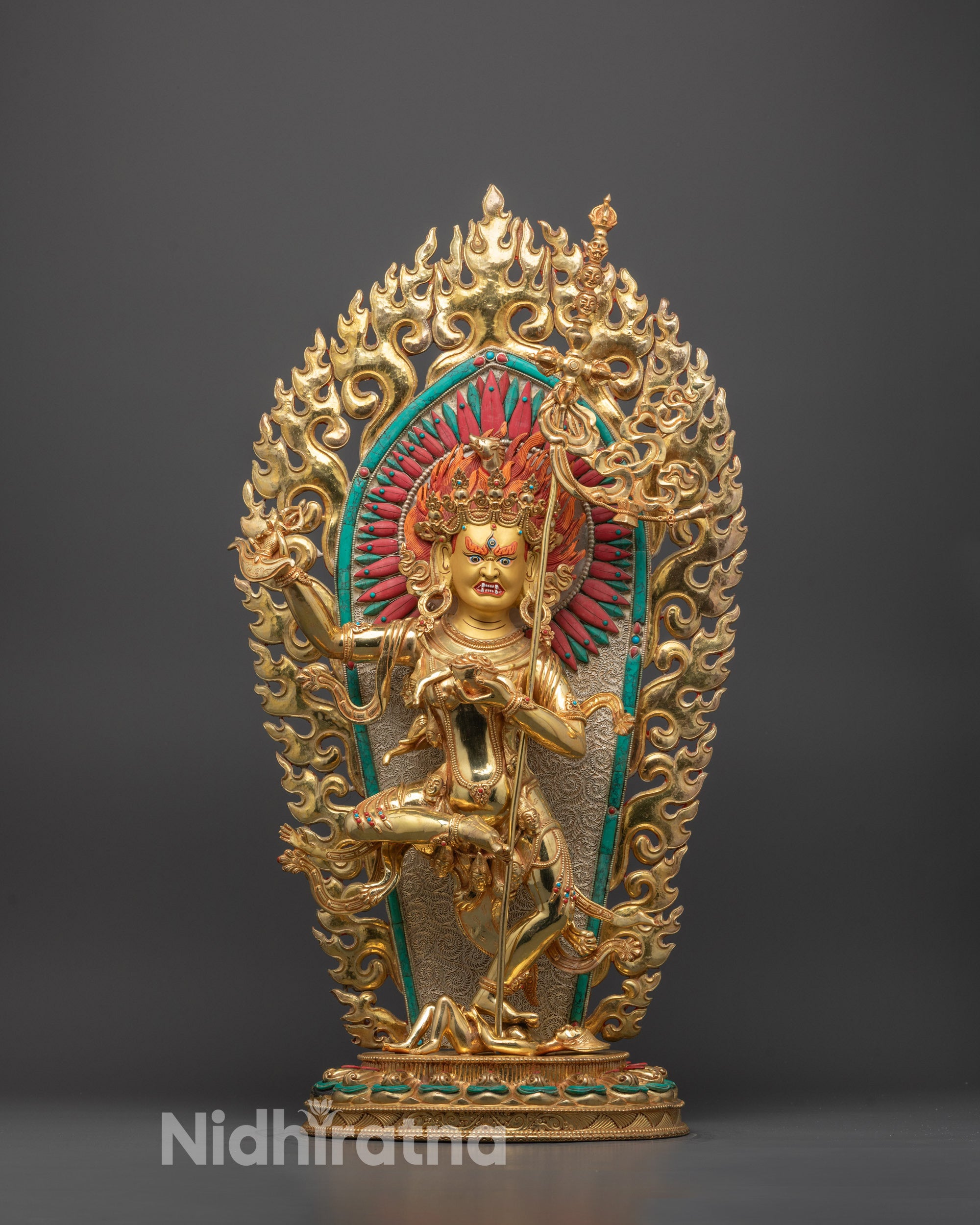 Front view of gold fire-gilded Troma Nagmo statue with wrathful expression and halo