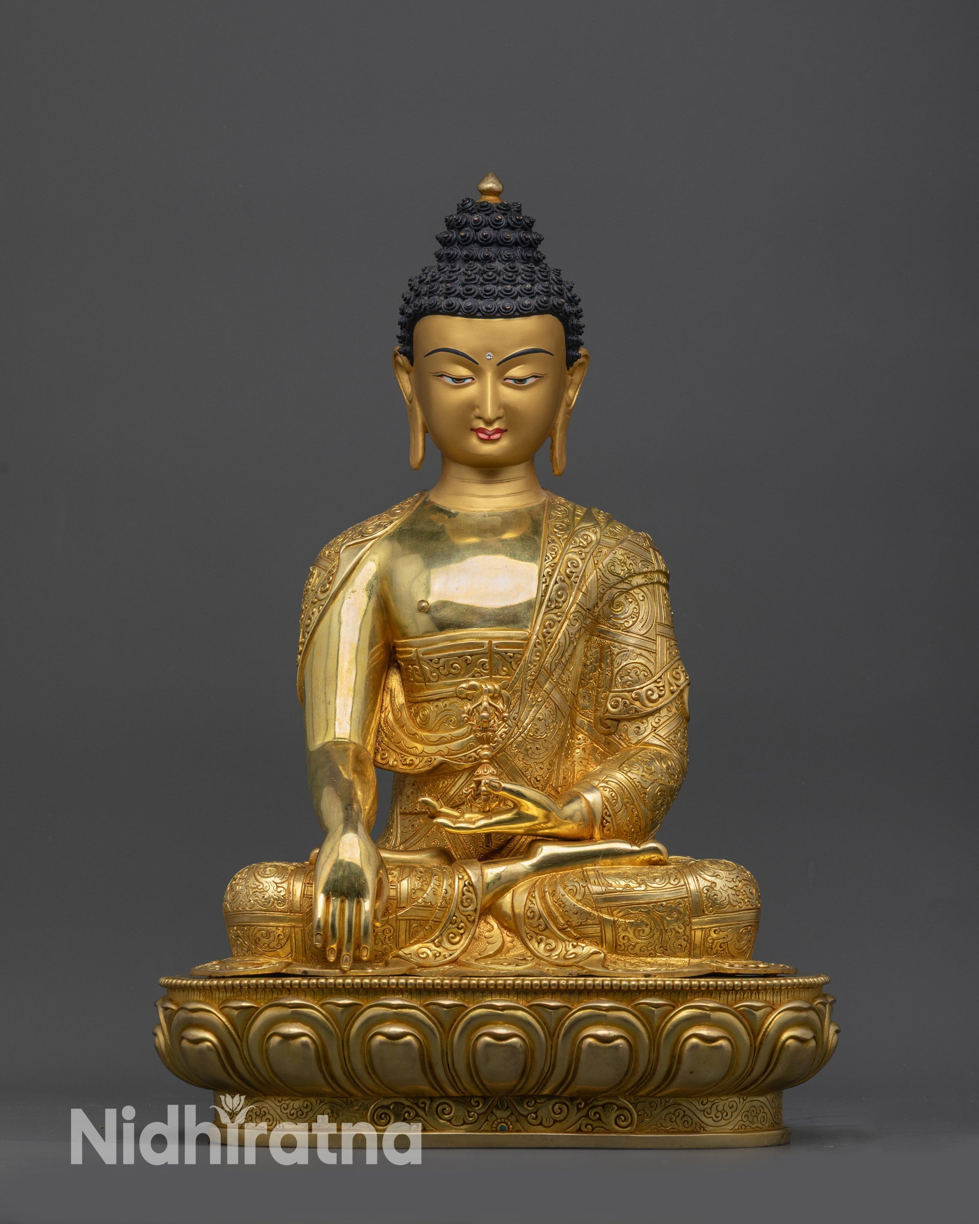 Front view of golden Akshobhya Buddha Mitrugpa statue on lotus pedestal for meditation
