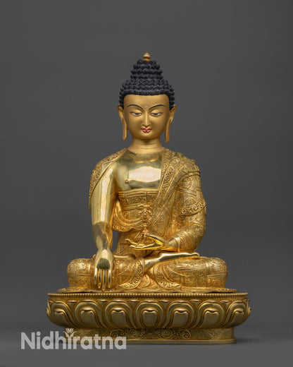 Front view of golden Akshobhya Buddha Mitrugpa statue on lotus pedestal for meditation
