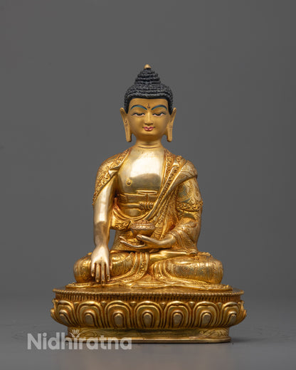 Front view of hand-carved Buddha Shakyamuni Statue seated on a lotus base holding a monk’s bowl