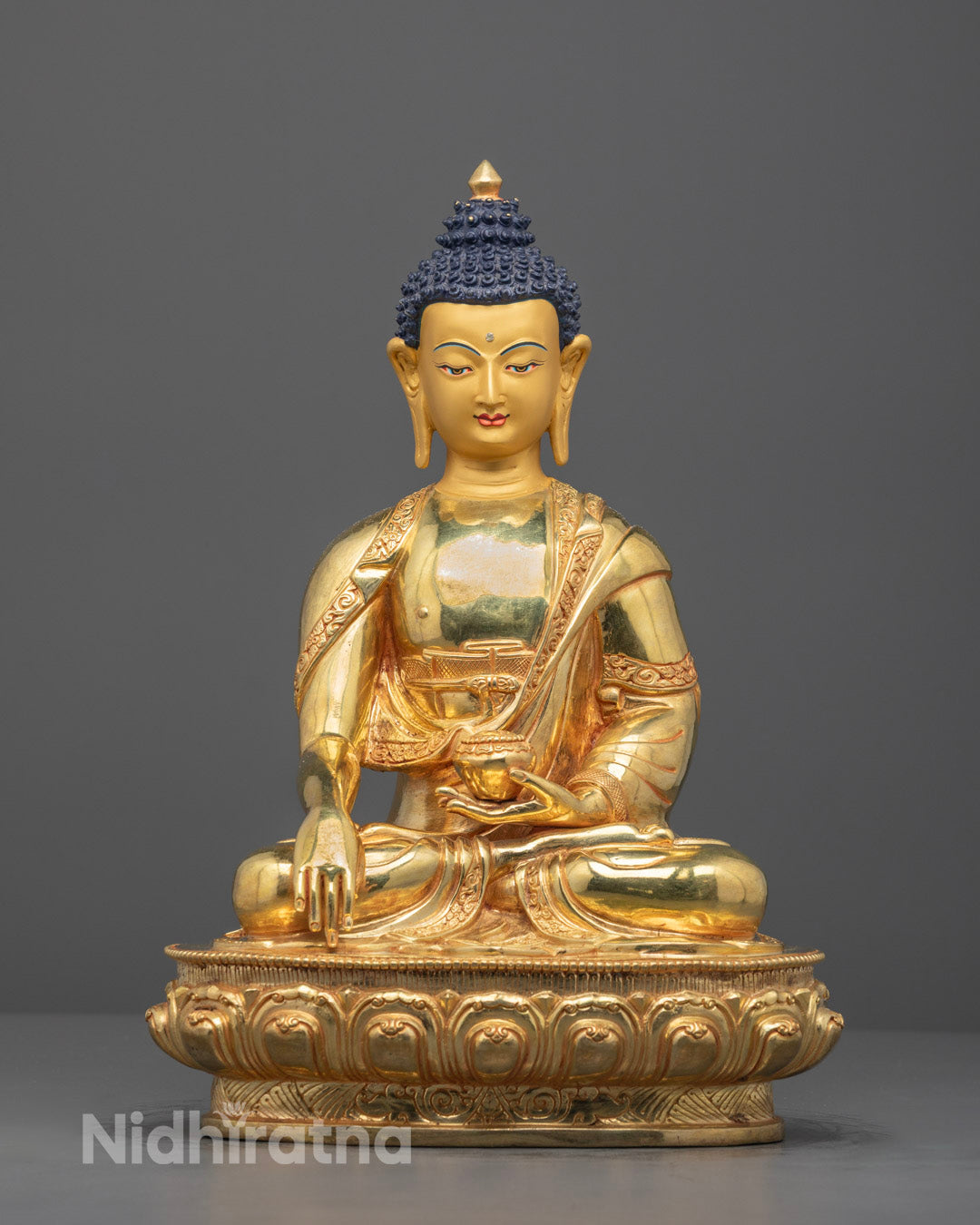 Front view of hand-carved Buddha statue seated on lotus throne with 24k gold gilding.