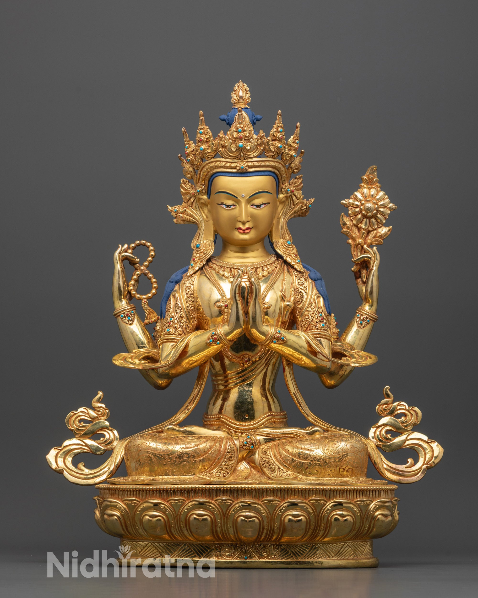 Front view of hand-carved Chenrezig Statue from Nepal showing four arms holding