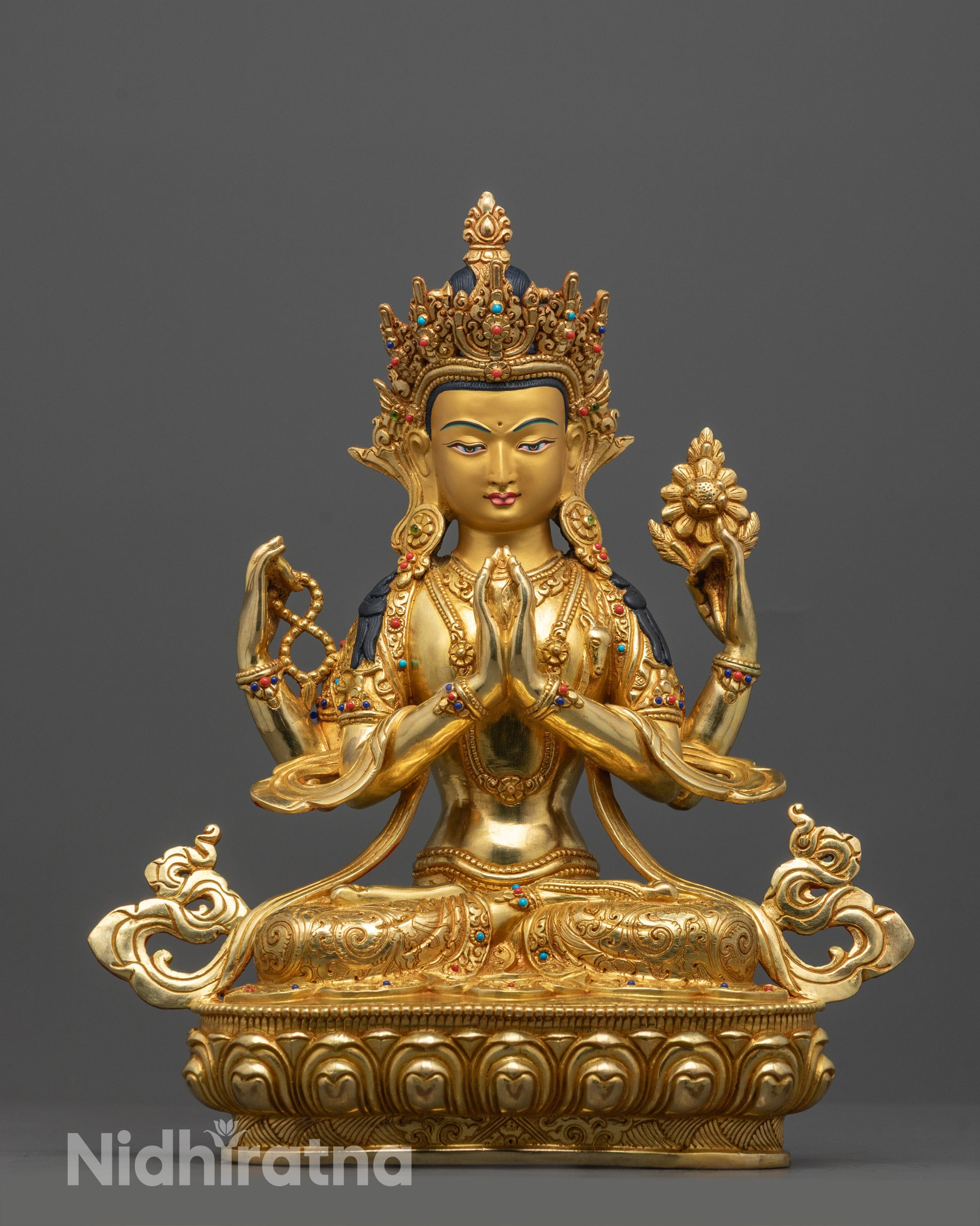 Front view of hand-carved Chenrezig statue seated on lotus base, gilded with 24k gold