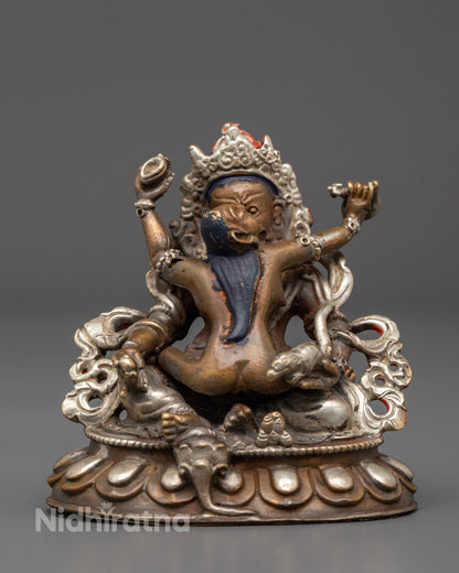 hand-carved Dzambhala with Yab-Yum statue in oxidized copper and silver finish, seated in union on a lotus base.