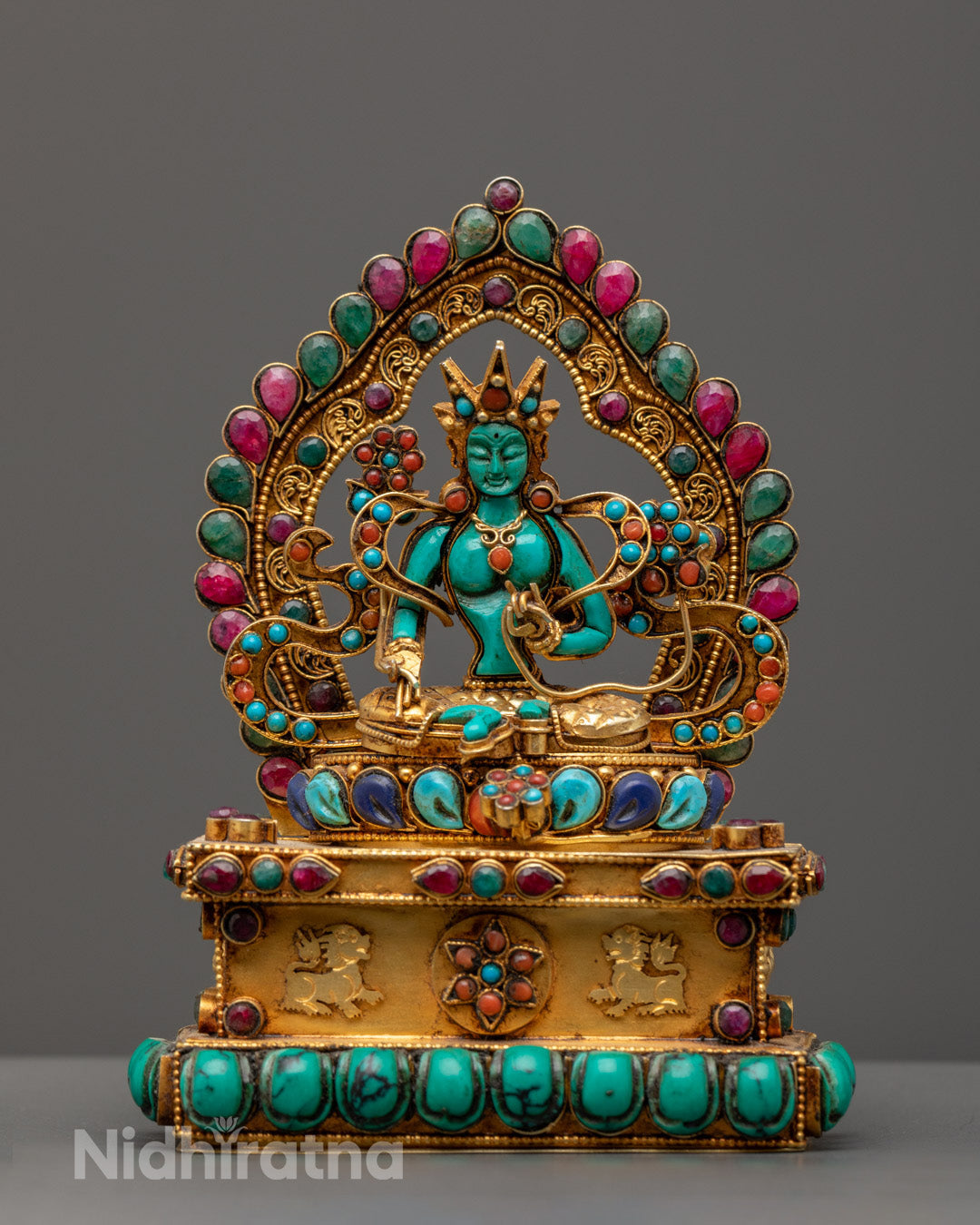 hand-carved Green Tara statue seated on lotus throne, adorned with crown and intricate jewelry, symbolizing compassion and swift protection.