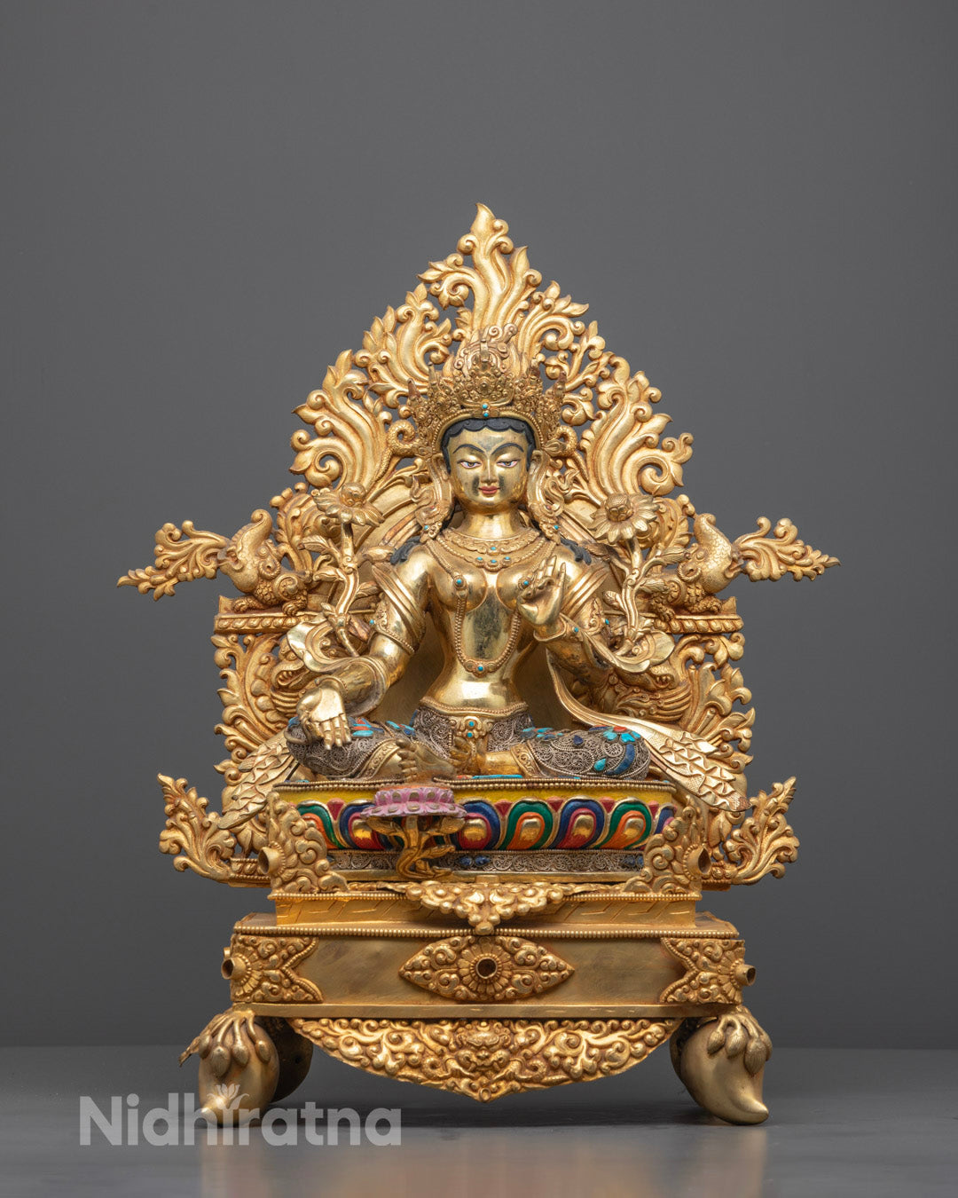 Front view of hand-carved Green Tara statue with 24k fire-gilded gold and lotus throne