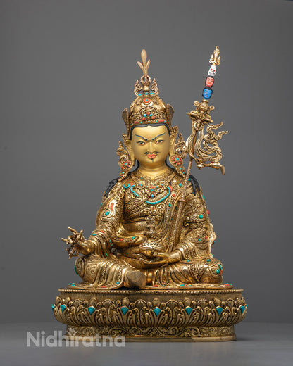 Front view of hand-carved Guru Rinpoche statue seated on lotus with vajra and skull cup