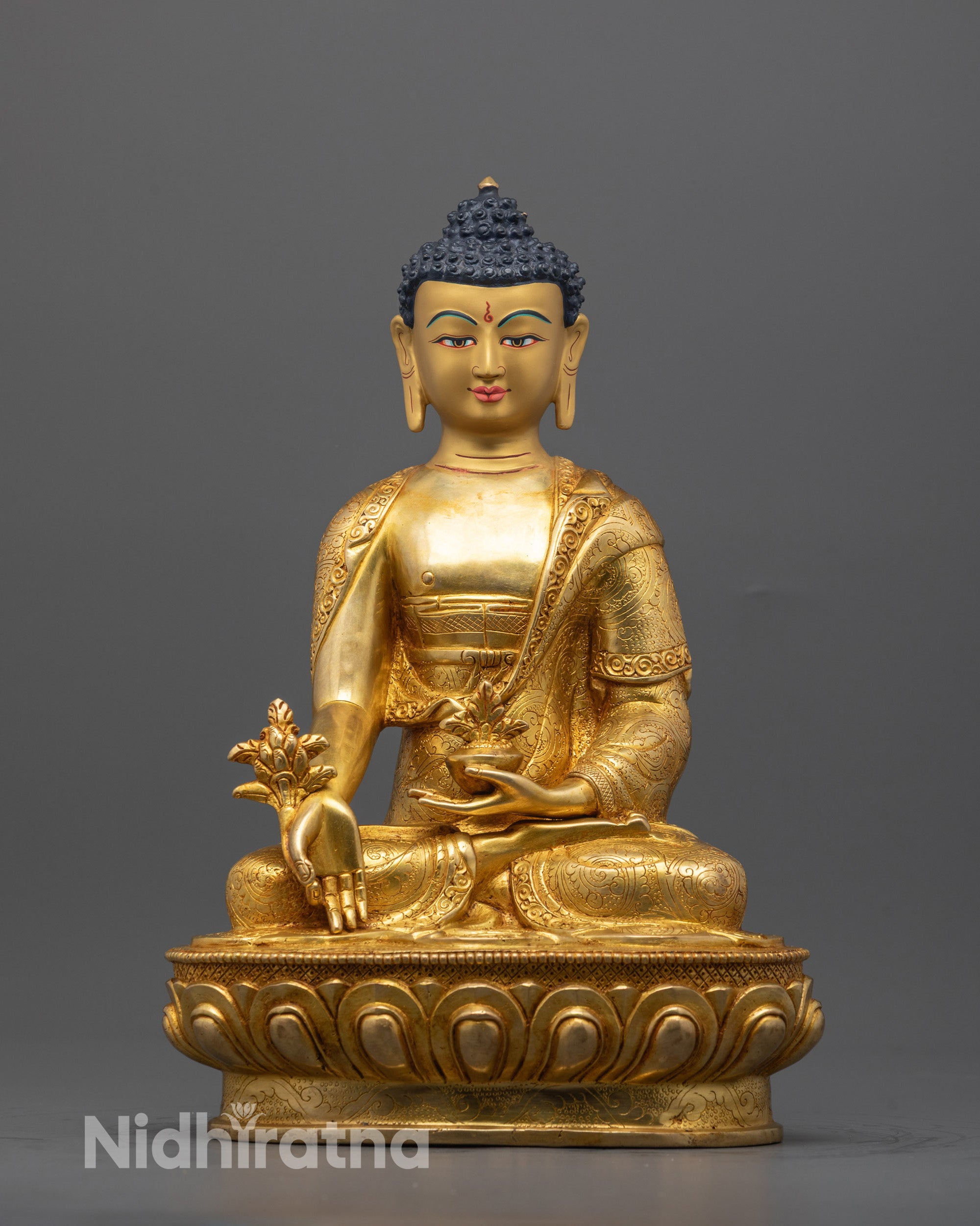 Front view of hand-carved Medicine Buddha Statue seated on lotus base with healing plant