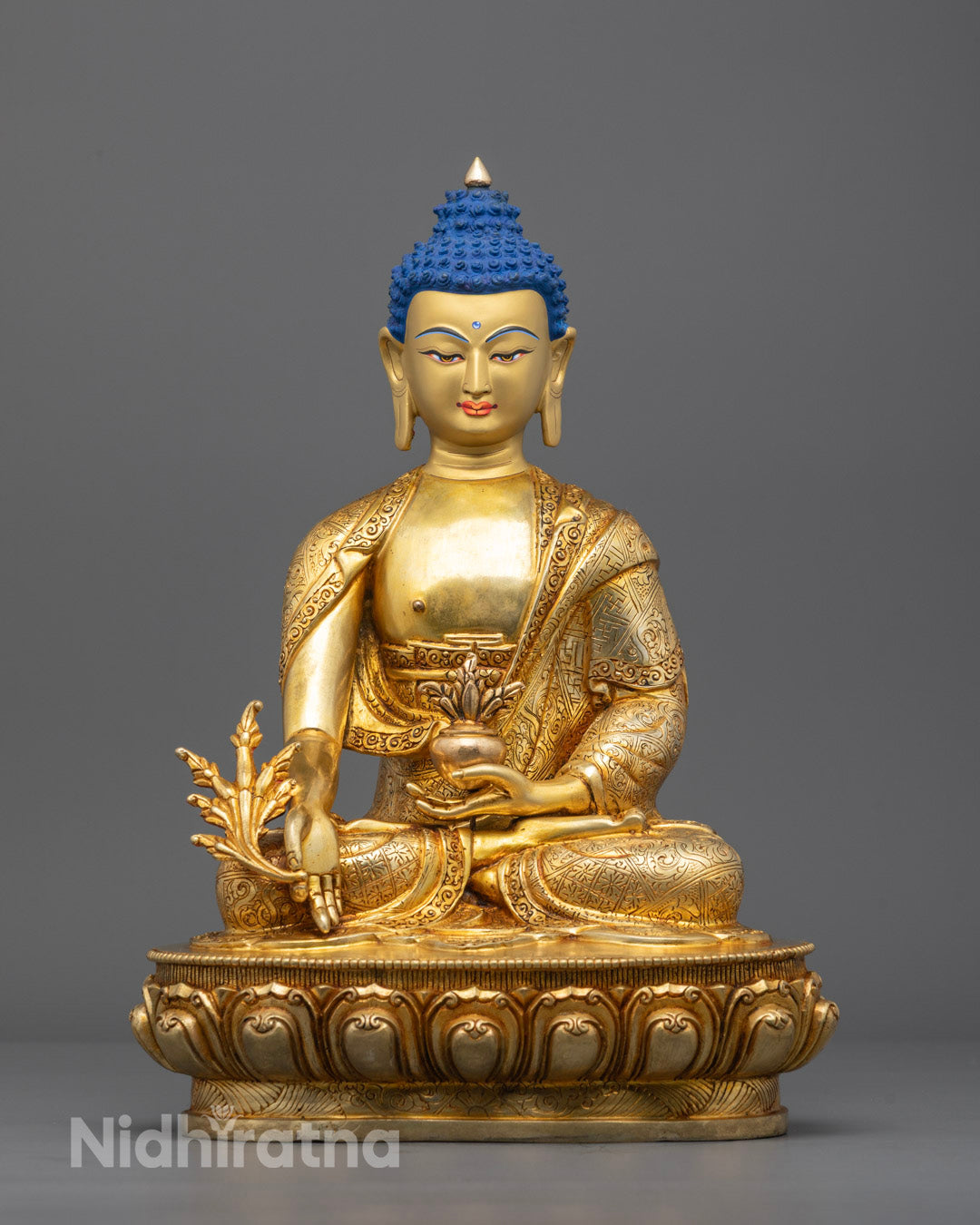 Front view of hand-carved Medicine Buddha statue with 24k fire-gilded gold on copper base