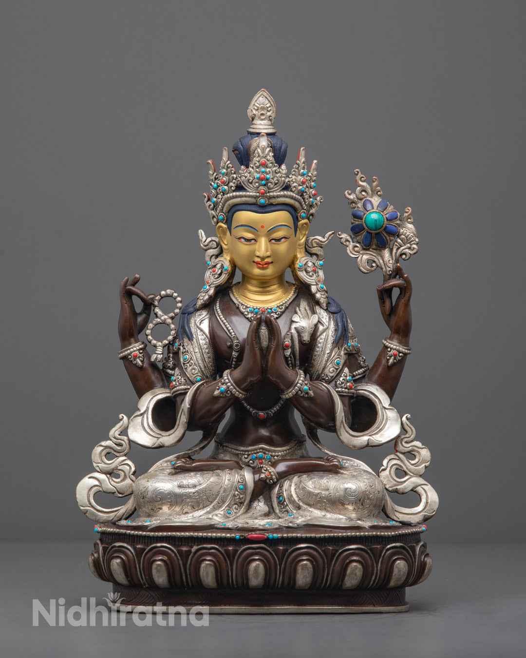 hand-carved Oxidized Chenrezig statue with silver-plated finish, 24k gold-gilded face, and adorned with semi-precious stones