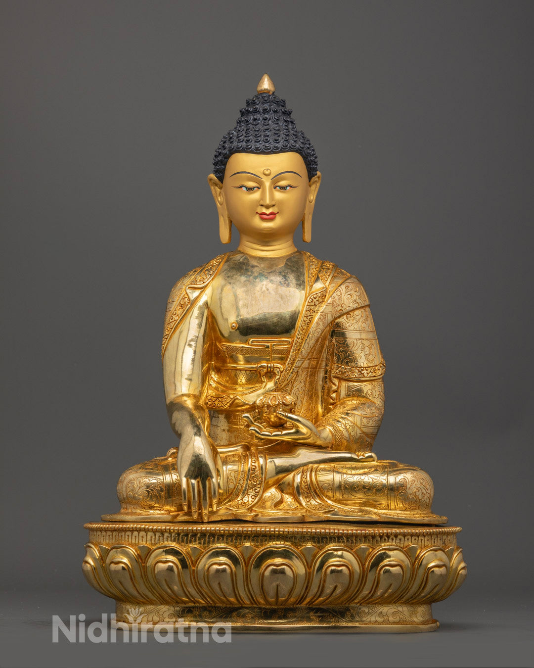 Front view of hand-carved Shakyamuni Buddha Statue with 24k gold gilded face and lotus throne base