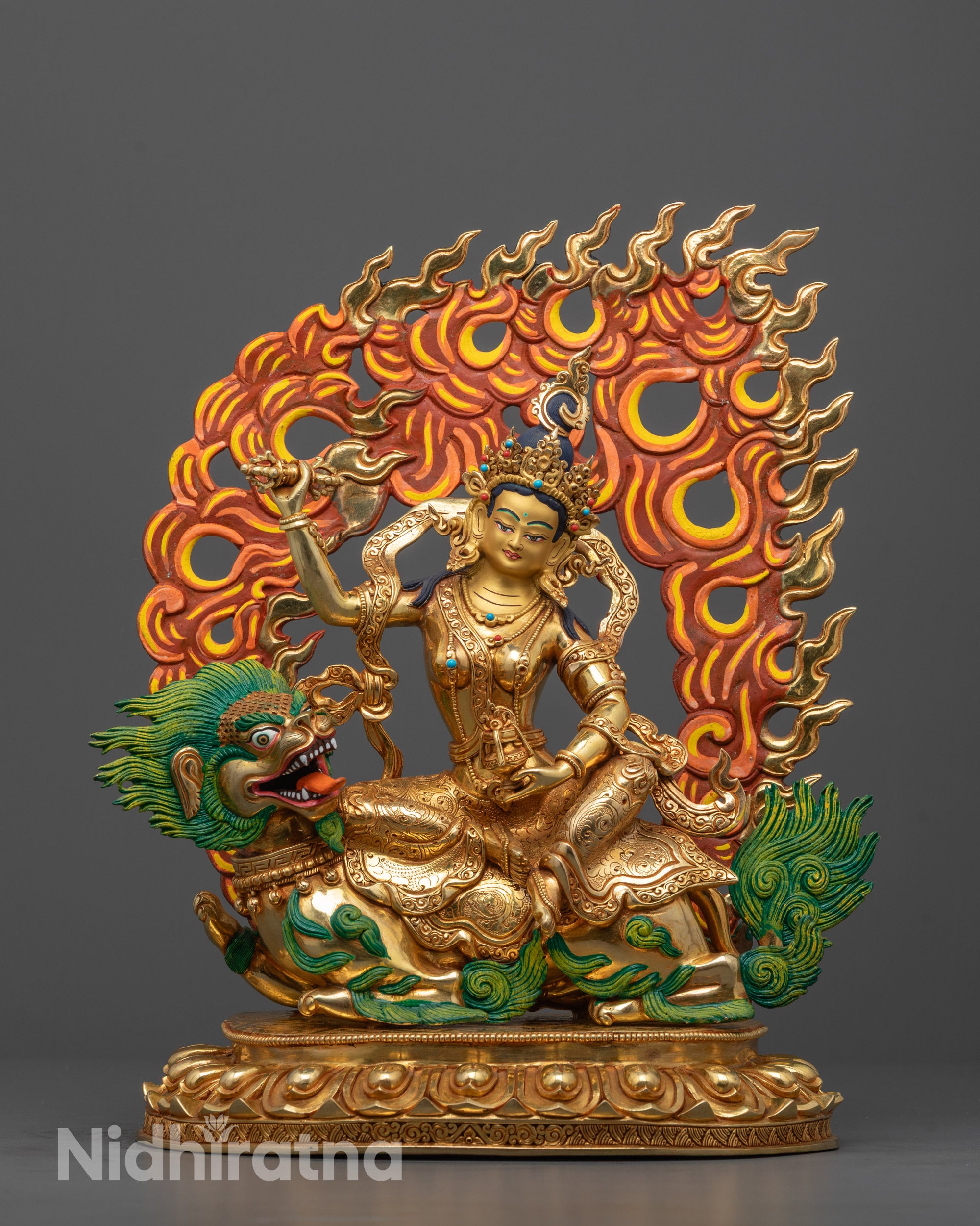 Front view of hand-carved Tsheringma statue seated on a white snow lion with neon mane