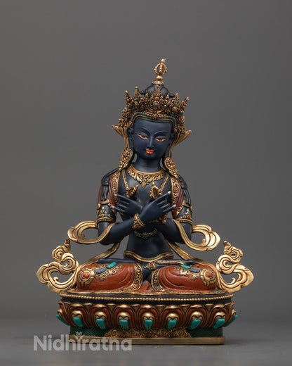 Front view of hand-carved Vajradhara statue with vajra
