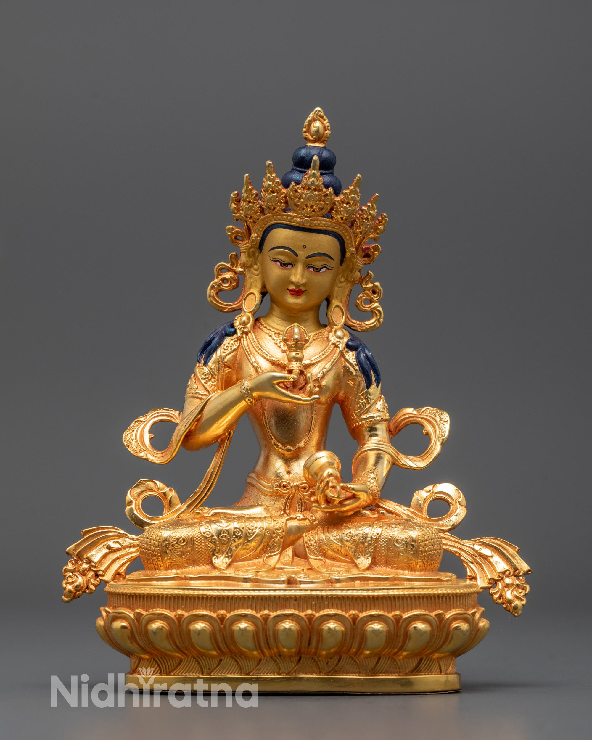 Front view of hand-carved Vajrasattva Statue seated on lotus with vajra and bell