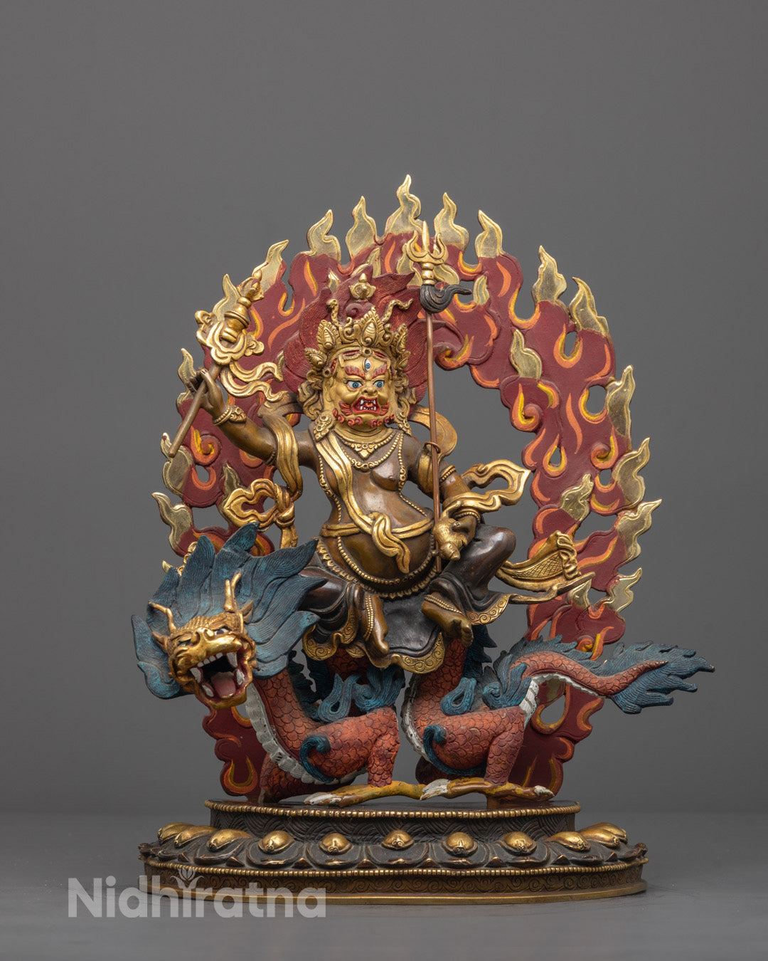 Front view of hand-carved White Dzambhala statue with gold-gilded face and colored halo
