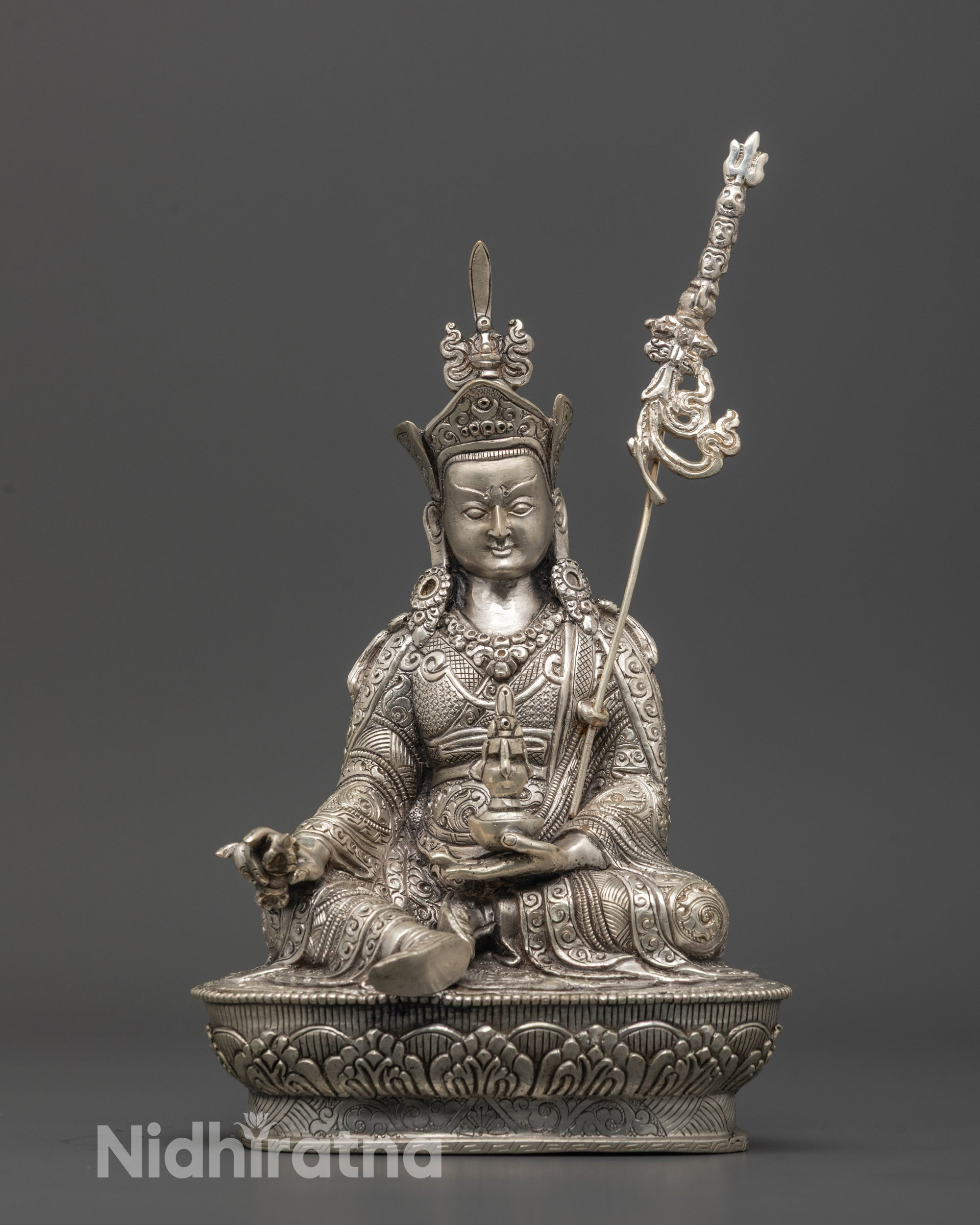 Front view of hand-carved silver-plated Guru Rinpoche sculpture from Nepal