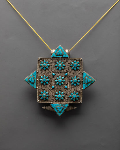 Front view of handcrafted Buddhist copper locket with turquoise gemstone