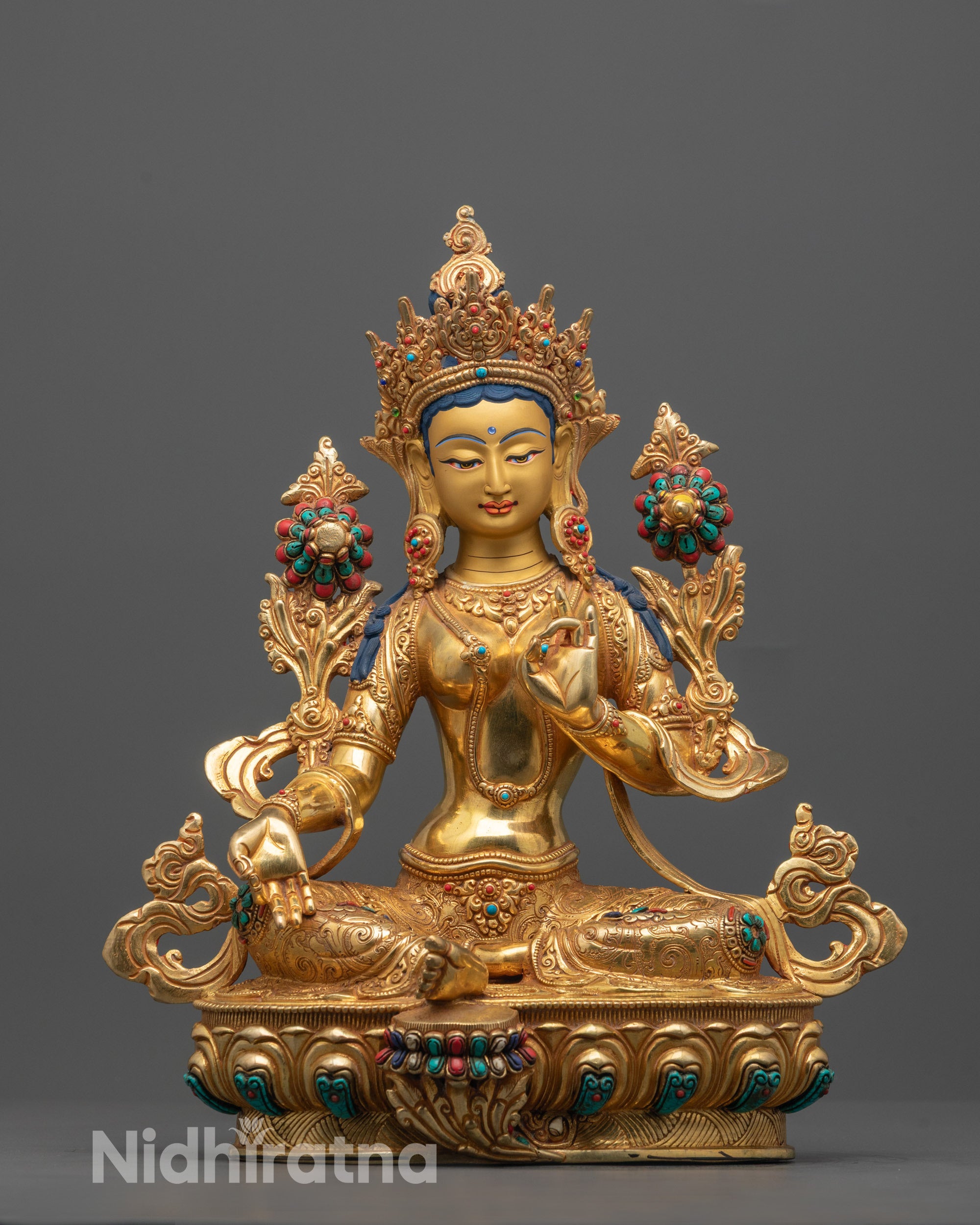 Front view of handcrafted Green Tara statue seated in meditation on a lotus base