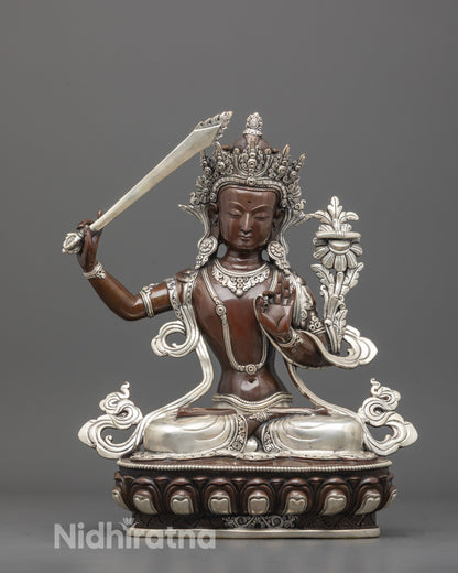 Front view of handcrafted Manjushri statue with silver details and lotus seat