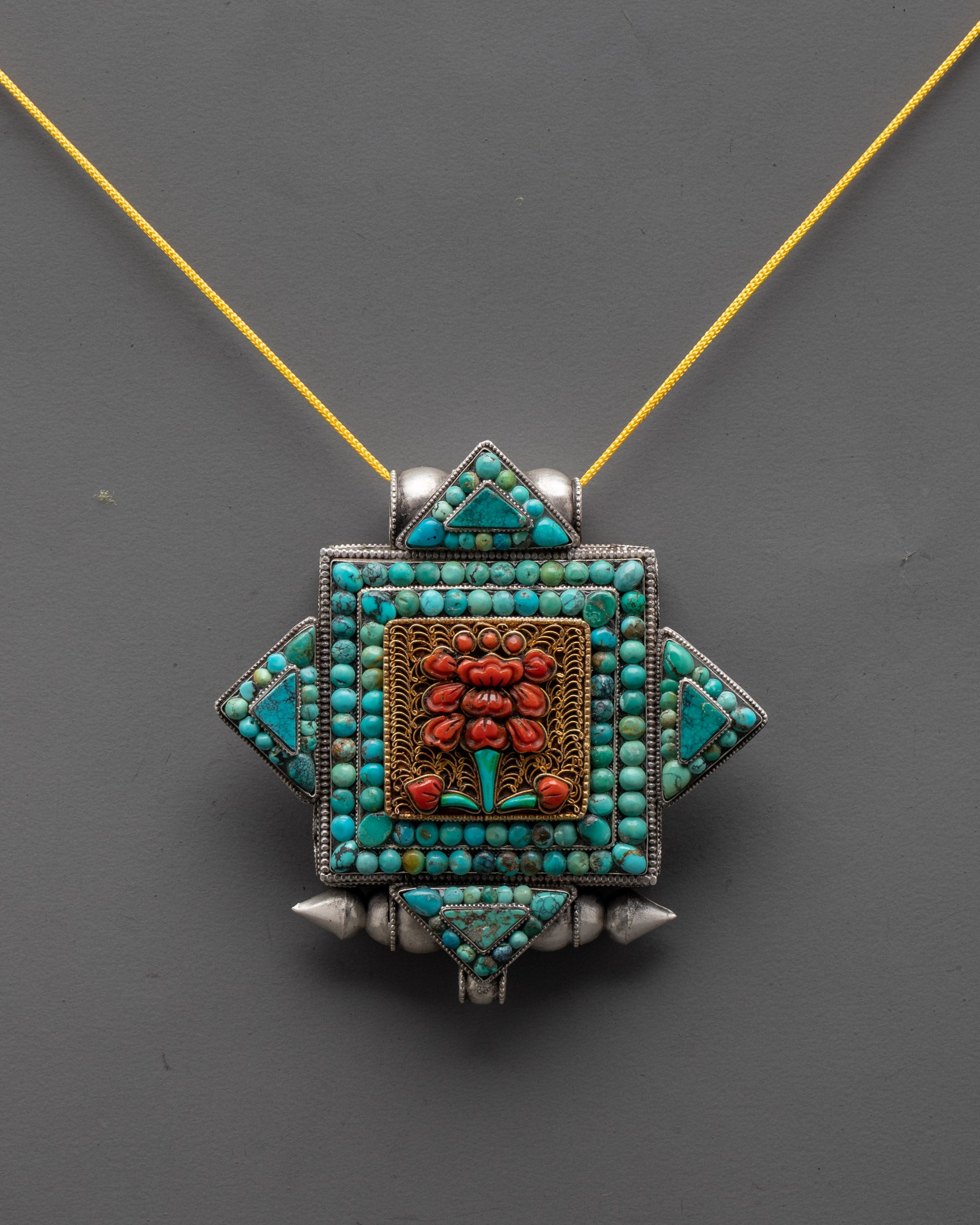 Front view of handcrafted flower locket necklace with coral and turquoise stones