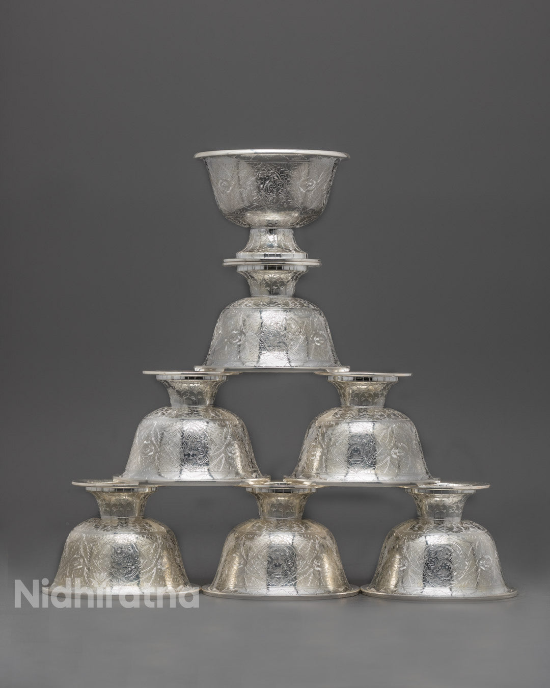 Front view of handcrafted pure silver water offering bowl with intricate carvings