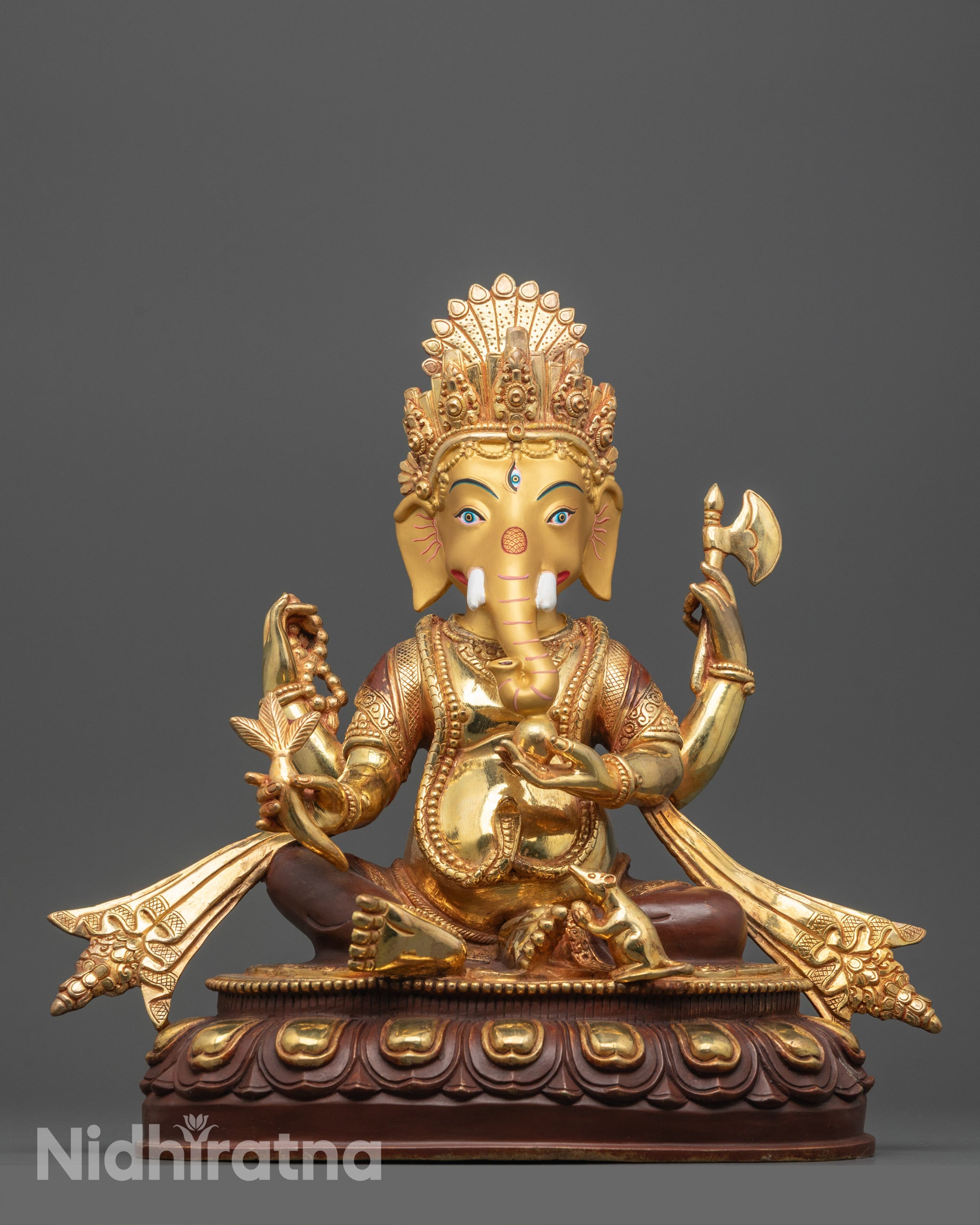 Front view of handmade Ganesh statue with gold-gilded face and copper base sculpture