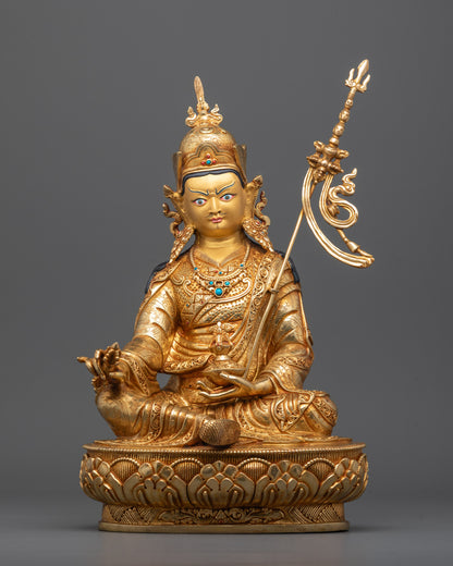 Front view of handmade Guru Rinpoche statue with gold-gilded face and lotus throne