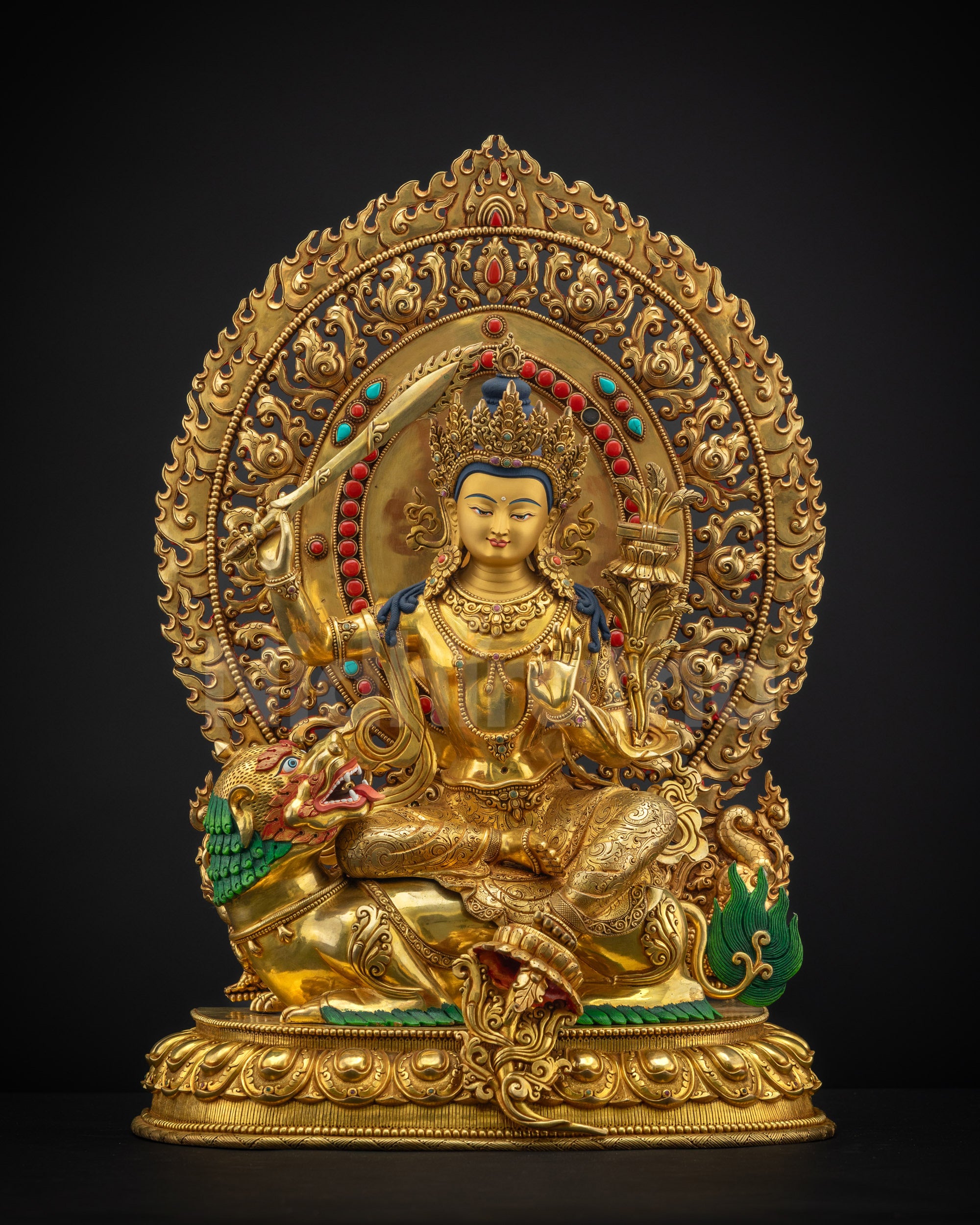Front view of lion-seated Simhada Manjushri statue in gold fire gilding with radiant halo