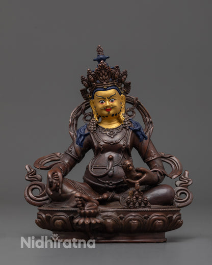 Front view of oxidized Dzambhala statue with gold-plated face and jewel-spitting mongoose