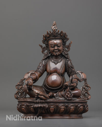 Front view of oxidized Dzambhala statue with jeweled crown and lotus seat detailed carving