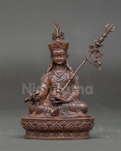 Front view of oxidized Guru Rinpoche Statue holding vajra and kapala on lotus pedestal