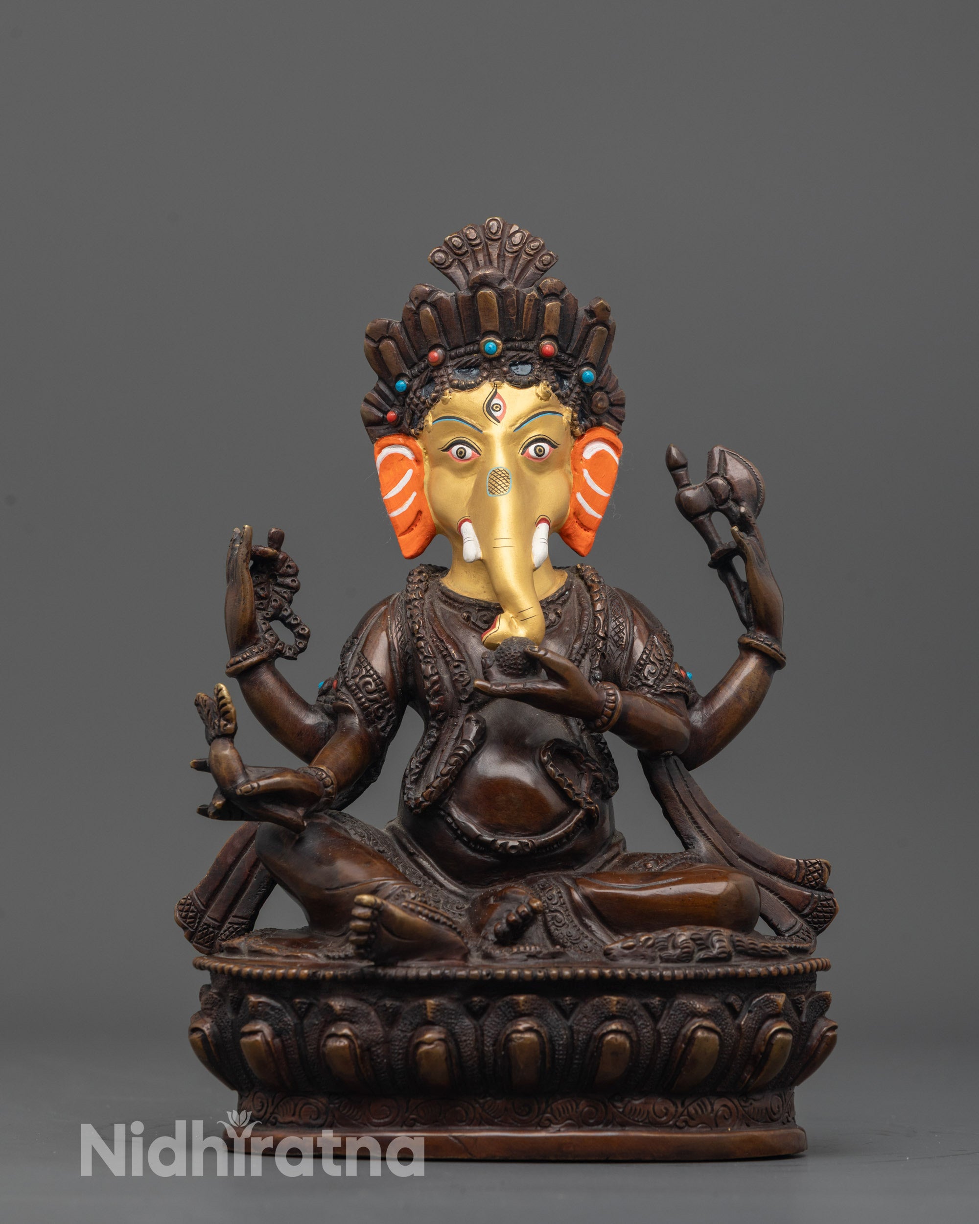 Front view of oxidized Lord Ganesha statue with gold-plated face and lotus throne details