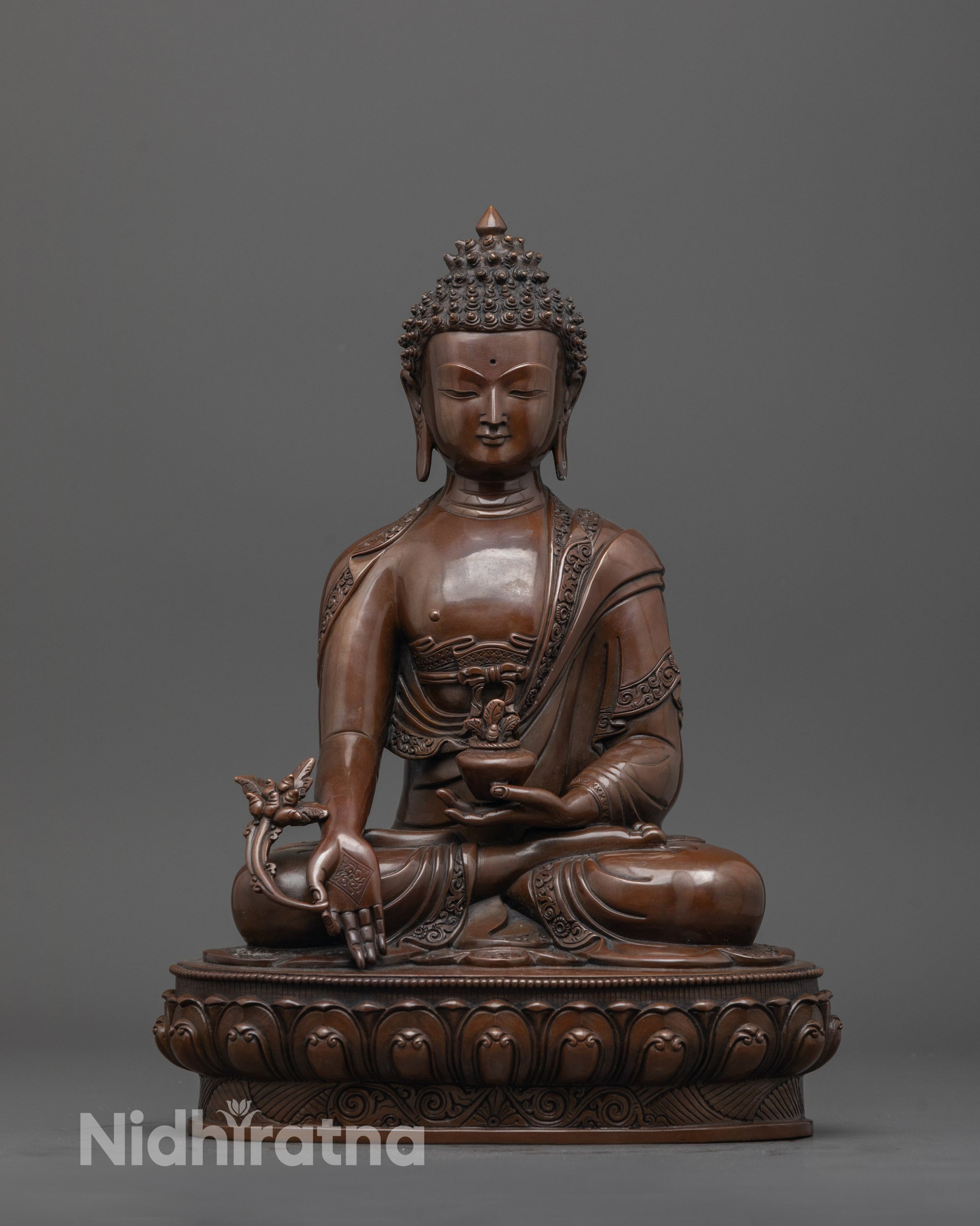 Front view of oxidized Medicine Buddha statue with nectar bowl and myrobalan plant details