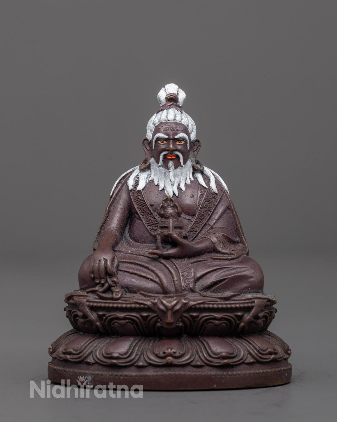 Front view of oxidized Thang Tong Gyalpo statue with lotus base and detailed carvings